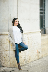 Young black long hair brunette woman resting in an urban scene.