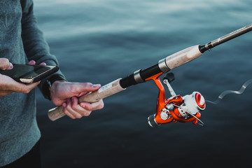 Fishing line going fast while the fisher is watching his phone.