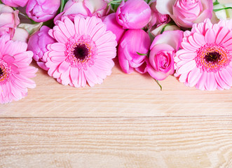 Pink flowers on wood - gerbera, roses, tulips
