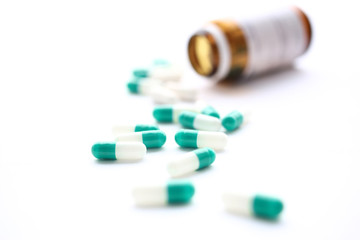 Pile of green and white pills arranged to scatter