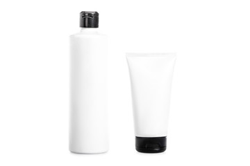 Studio shot of cream tube and bottle of hair conditioner isolated on white