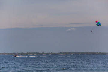 couple enjoy parasailing on a sunny vacation day on the tourist destination Mactan Island