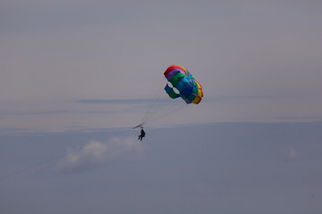 couple enjoy parasailing on a sunny vacation day on the tourist destination Mactan Island