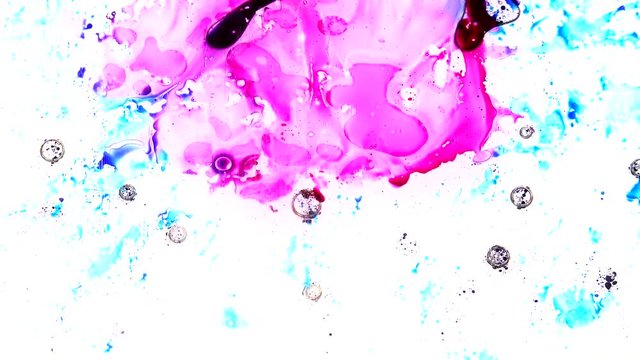 Ink is squashed in between 2 sheets of glass and spreads out creating colourful effects