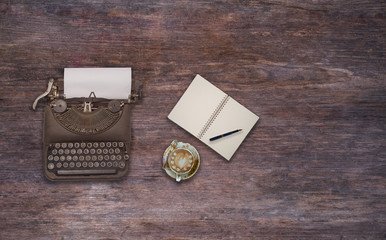 Vintage typewriter on the old wooden desk 