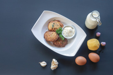 potato pancakes on a white plate. Milk, eggs, farm products.