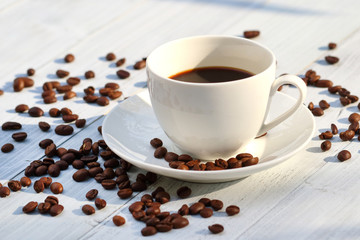 Coffee cup and coffee beans on the table 