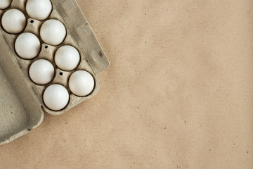 Fototapeta na wymiar Cardboard egg rack with eggs on rustic background with copy space