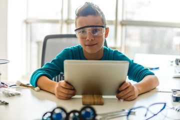 Teenage boy looking at digital tablet