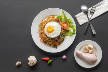 Asian dish fried noodles with egg and seafood or beef or chicken