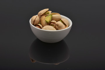 Roasted pistachio seeds with shell in bowl