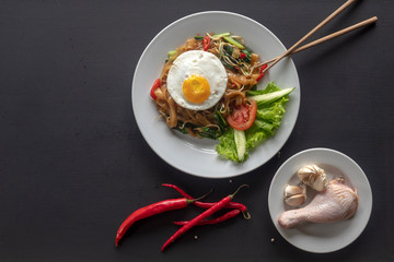 Asian dish fried noodles with egg and seafood or beef or chicken