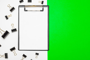 Fototapeta na wymiar Blank clipboard paper on bright green paper background, copy space