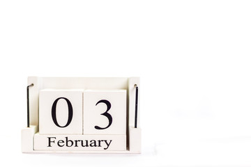 the day of February on a white clear background. a wooden desktop calendar that reminds us of what date we are today.