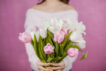 Close-up Young woman holding Bouquet of pink Tulips Pink background Spring Holidays