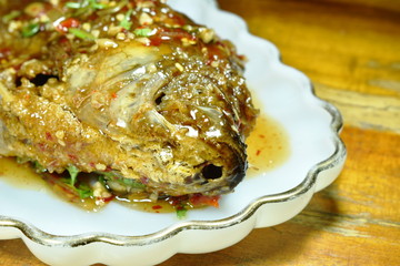 deep fried mango fish dressing sweet chili sauce on plate