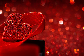 Valentines day background with giftbox.  Red space background. Red love concept background with defocused lights. Heart shape.