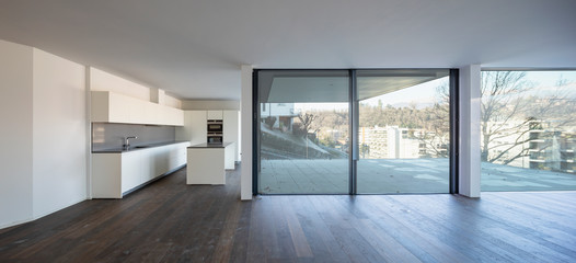 Fototapeta premium Front view of modern white kitchen