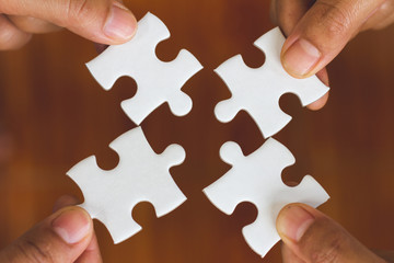 Many persons holding pieces of jigsaw puzzle,Teamwork concept,,Business connection,Success and strategy concept,Business accounting