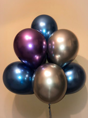 Composition of helium balloons in chrome blue, silver and purple colors