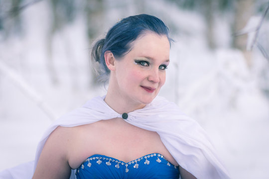 Lady in blue in midst of finnish winter forest