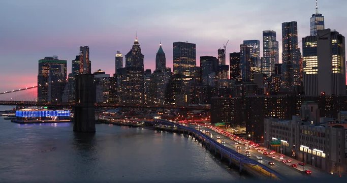 View from above of the Brooklyn Bridge, traffic in the FDR highway and the lower Manhattan skyline in the Financial District of New York City, NY.