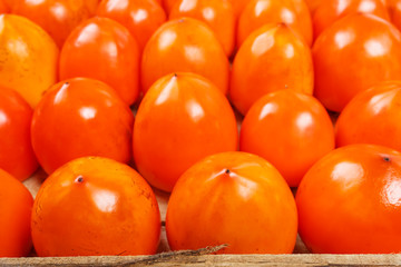 Fresh ripe persimmons in market. Persimmons background.