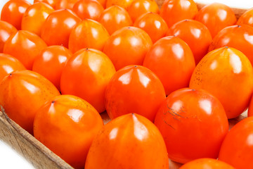 Fresh ripe persimmons in market. Persimmons background.