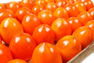 Fresh ripe persimmons in market. Persimmons background.