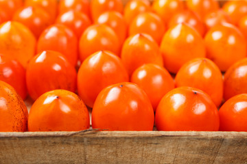 Fresh ripe persimmons in market. Persimmons background.