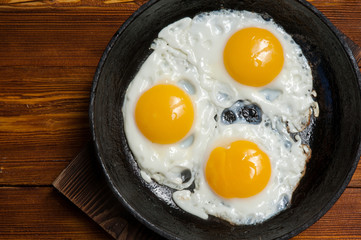 Fried eggs in cast-iron pan. Top view.