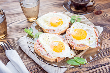 Breakfast. Toast with the finest meat and fried egg.