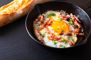 Food concept Fried egg and cheese bacon in cast iron skillet with copy space
