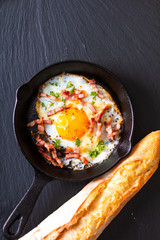 Food concept Fried egg and cheese bacon in cast iron skillet with copy space