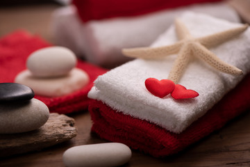 Fototapeta na wymiar Wellness docoration on valentine's day with towels and stones