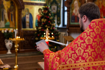 The holy father in the temple lights candles to start the wedding ceremony.