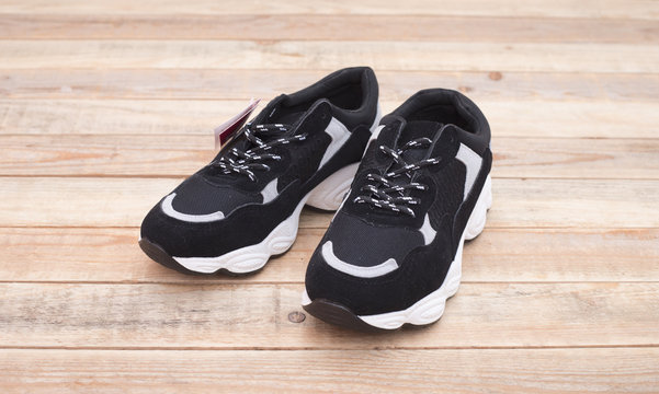 Sport shoes at wood background, close-up