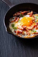 Food concept Fried egg and cheese bacon in cast iron skillet with copy space
