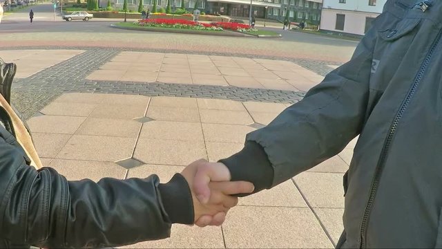 Closeup of Handshake with city background