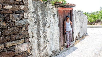 Woman walking through streets of Greek Village