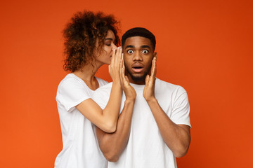 Black woman whispering her desires to shocked boyfriend