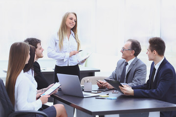 Fototapeta premium Businesswoman explaining business plan to her colleagues