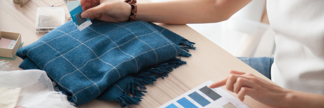 Close up busy fashion designer woman hands hold blue samples swatches make choose check color of textile fabric, dressmaker tailor occupation concept. Horizontal photo banner for website header design