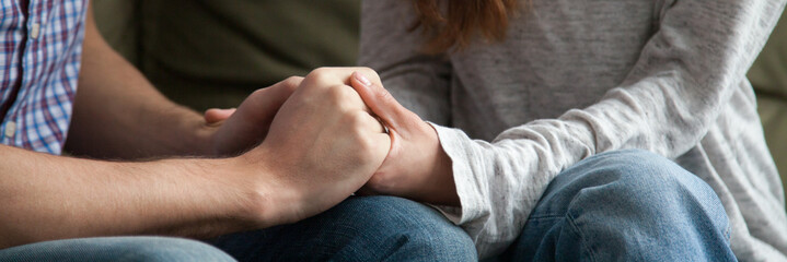 Close up horizontal photo of couple in love holding hands loving wife supporting encouraging...