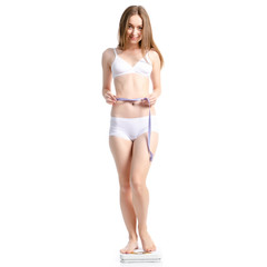 Fototapeta premium Beautiful woman standing on weighing scale centimeter weight loss on white background isolation