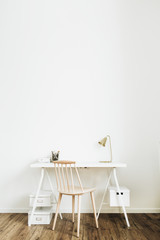 Fototapeta na wymiar Bright home office desk workspace. Nordic modern minimal interior design concept. Desktop table and wooden chair in white room.