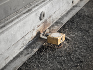 close up key lock on shutter door with selective color focus , monochrome