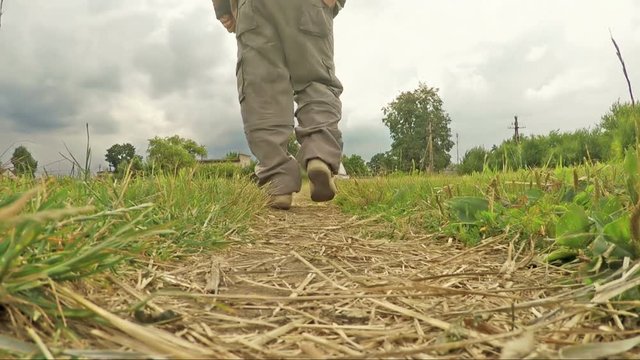 Man walking along a footpath in the countryside