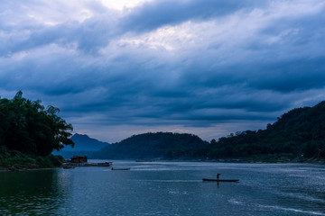 Sunset at mekong river. Blue hour with a lot of clouds. Some boats in the river. Cloudy scene in luang prabang, laos