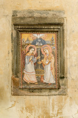 Old house wall adorned with painted icon in historic part of Lviv near Market Square, Ukraine